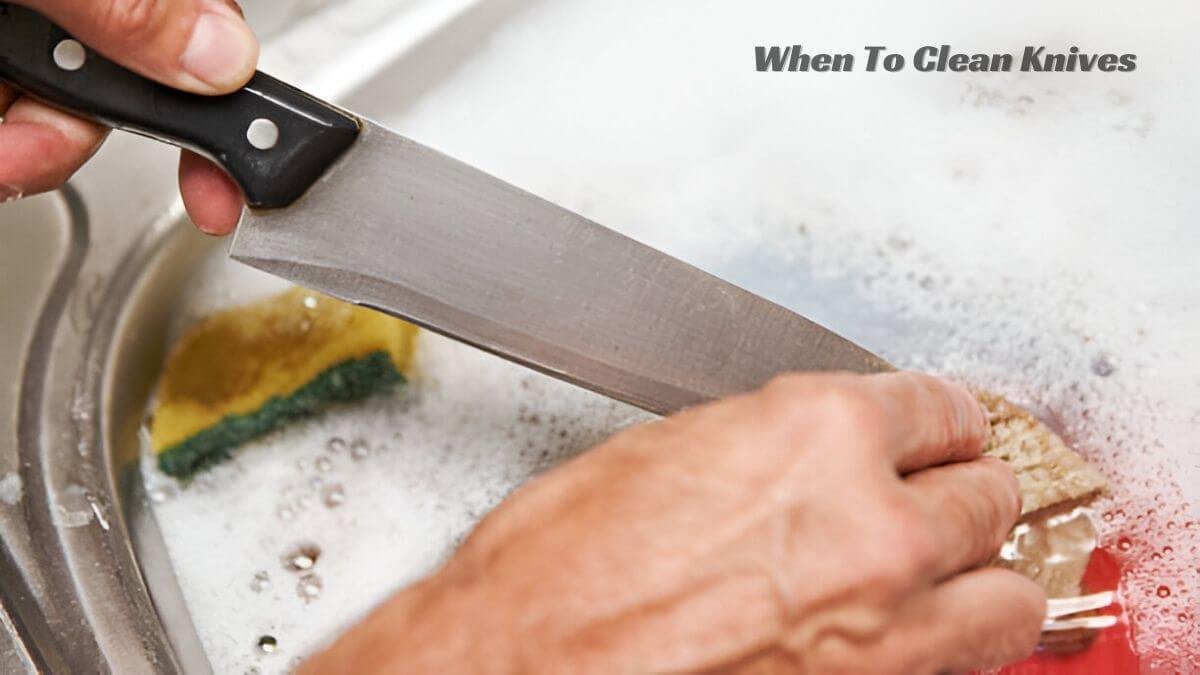 A person sanitizing a knife in soapy water