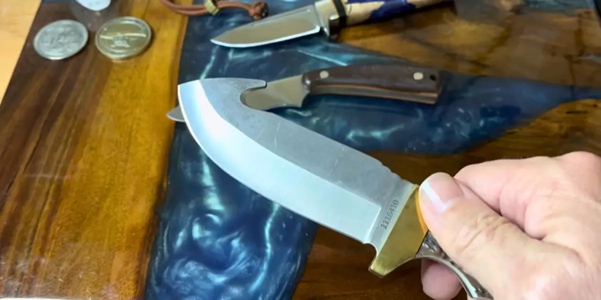 A man prepares to sharpen a gut hook knife